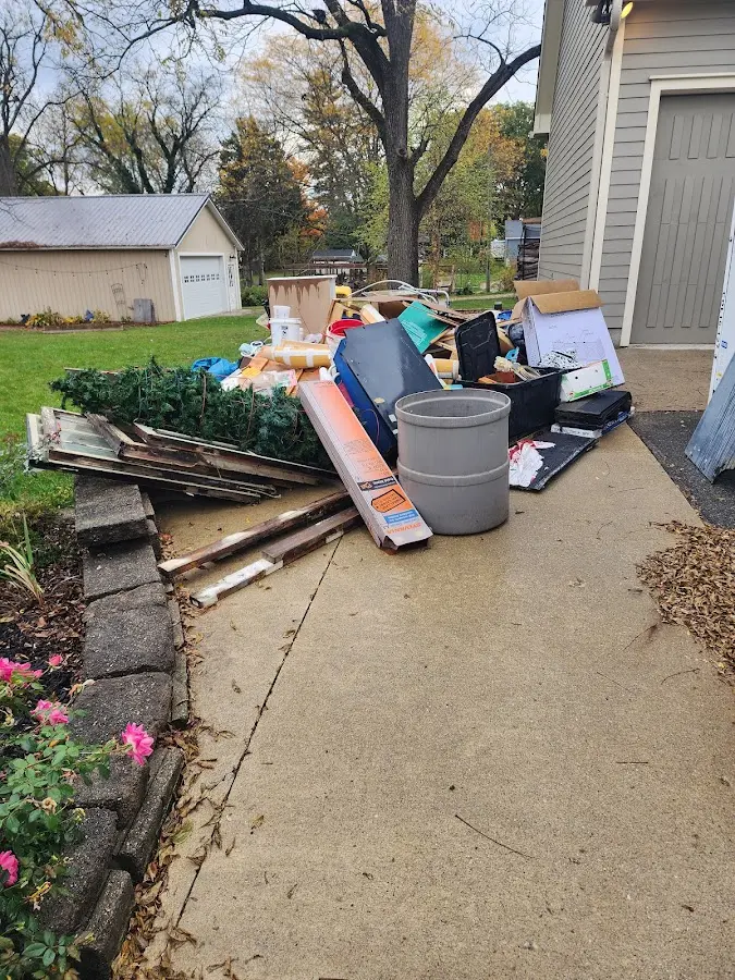 Dumpster being loaded with debris for Estate Cleanout Dumpster Rental in Cohasset